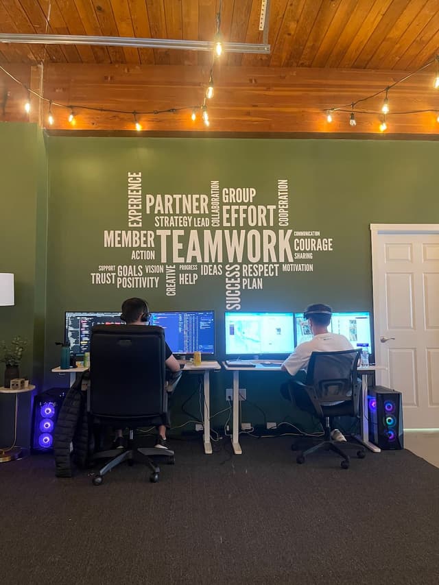 Two team members working at computer desks